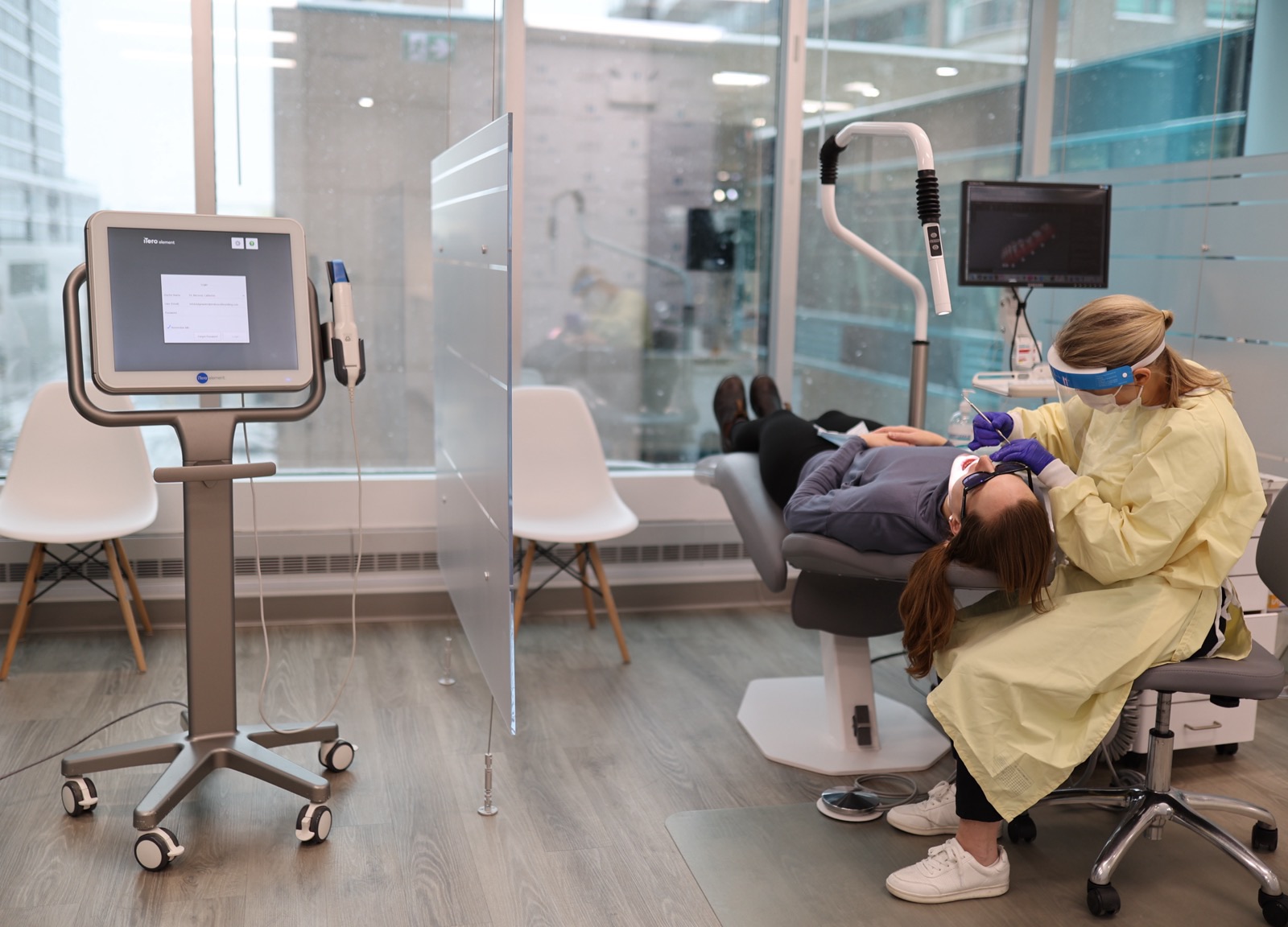 Dr. Catherine McLeod treating an adult patient at Embrace Orthodontics, with the iTero scanner in the foreground