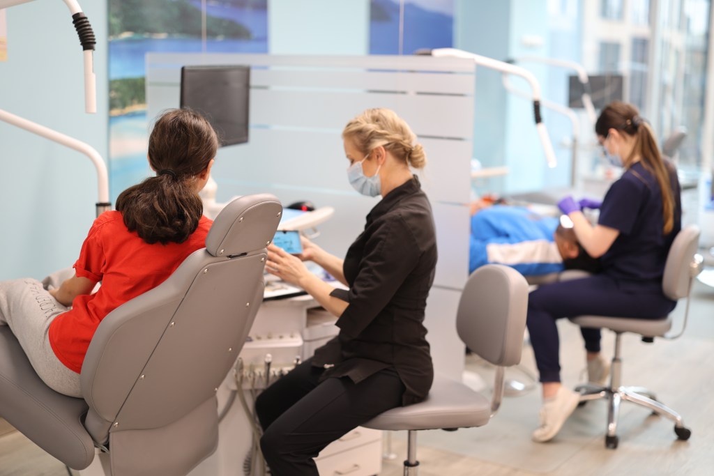 The Embrace Orthodontics team caring for patients in the sunny clinical area
